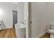 Bright bathroom with freestanding tub, wood-style flooring and access to other rooms for convenience at 2444 Jacobs St, Port Charlotte, FL 33953
