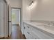 Bright bathroom featuring double vanity, quartz countertop and a doorway to a bedroom at 2444 Jacobs St, Port Charlotte, FL 33953