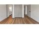 Bright bedroom featuring wood floors, multiple doorways, and a large closet at 2444 Jacobs St, Port Charlotte, FL 33953