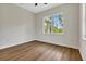 Bright bedroom featuring wood-look flooring, ceiling fan and a large window at 2444 Jacobs St, Port Charlotte, FL 33953