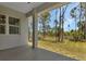 Spacious covered patio with backyard view of sunny landscaping and trees at 2444 Jacobs St, Port Charlotte, FL 33953
