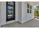 Modern front door with glass panels and white trim, offering plenty of natural light at 2444 Jacobs St, Port Charlotte, FL 33953