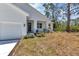 Front exterior of modern home with manicured landscaping and a two-car garage at 2444 Jacobs St, Port Charlotte, FL 33953