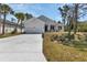 Charming one-story home boasts a manicured lawn, a two-car garage and a modern exterior at 2444 Jacobs St, Port Charlotte, FL 33953