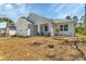 Exterior of white home with well-maintained lawn, landscaping and two-car garage at 2444 Jacobs St, Port Charlotte, FL 33953