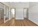 Bright hallway with wood flooring, neutral walls, and doors to other rooms at 2444 Jacobs St, Port Charlotte, FL 33953