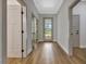 Light-filled hallway featuring beautiful wood floors and neutral paint throughout the home at 2444 Jacobs St, Port Charlotte, FL 33953