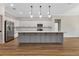 Bright, open kitchen boasts modern appliances, a large island, and wood floors at 2444 Jacobs St, Port Charlotte, FL 33953