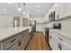 Modern kitchen featuring stainless steel appliances, white cabinets, and a spacious island with a farmhouse sink at 2444 Jacobs St, Port Charlotte, FL 33953