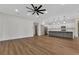 An open living room with wood floors, neutral walls, and a modern kitchen in the background at 2444 Jacobs St, Port Charlotte, FL 33953