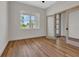 Bright office space with wood flooring, large window, and an open doorway to hallway at 2444 Jacobs St, Port Charlotte, FL 33953