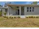 Rear of home with a covered patio and beautiful landscaping in sunny backyard at 2444 Jacobs St, Port Charlotte, FL 33953