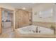 Modern bathroom featuring a jacuzzi tub and glass shower enclosure at 2605 Fulton Sw St, Largo, FL 33774