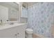 Clean bathroom with white vanity, seashell accents, and coordinating shower curtain at 2605 Fulton Sw St, Largo, FL 33774
