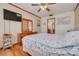 Cozy bedroom features wood flooring, wall mounted tv, and coastal decor at 2605 Fulton Sw St, Largo, FL 33774