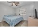 Neutral bedroom with ceiling fan, light-colored floors, and a decorative wall shelf at 2605 Fulton Sw St, Largo, FL 33774