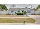 Charming single-story home with manicured landscaping and a well-maintained front yard at 2605 Fulton Sw St, Largo, FL 33774
