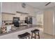 Kitchen area with an island, bar stool seating, and stainless steel appliances at 2605 Fulton Sw St, Largo, FL 33774