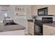 Well-lit kitchen with stainless steel appliances and decorative beach decor at 2605 Fulton Sw St, Largo, FL 33774