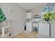 Functional laundry room with washer, dryer, and plenty of storage space at 2605 Fulton Sw St, Largo, FL 33774