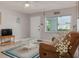 Inviting living room with a comfortable sofa, bright windows, and tasteful decor at 2605 Fulton Sw St, Largo, FL 33774
