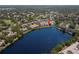 Aerial view of waterfront condos overlooking a serene lake in a lush, green neighborhood at 2782 Countryside Blvd # 2, Clearwater, FL 33761