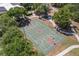 Aerial view of a full-size basketball court surrounded by trees and sidewalks, offering a recreational amenity at 2782 Countryside Blvd # 2, Clearwater, FL 33761