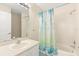 Bathroom with a combined tub and shower and decorative blue shower curtain at 2782 Countryside Blvd # 2, Clearwater, FL 33761