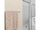 Bathroom featuring a glass shower, white tiling, and tan hand towel at 2782 Countryside Blvd # 2, Clearwater, FL 33761