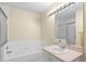 Bright bathroom with tub and shower combo and ample counter space at 2782 Countryside Blvd # 2, Clearwater, FL 33761