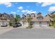 A townhouse row featuring charming exteriors, each with a two-car garage and beautifully landscaped yards at 2782 Countryside Blvd # 2, Clearwater, FL 33761