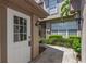 A bright front door and walkway, framed by lush landscaping and tasteful exterior lighting fixtures at 2782 Countryside Blvd # 2, Clearwater, FL 33761