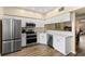 Modern kitchen with stainless steel appliances and bright, white cabinets at 2782 Countryside Blvd # 2, Clearwater, FL 33761