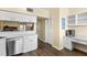 Eat-in kitchen with white cabinets and counter space at 2782 Countryside Blvd # 2, Clearwater, FL 33761