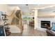 Inviting entryway with wood staircase, fireplace, and wood-look tile floors at 2782 Countryside Blvd # 2, Clearwater, FL 33761