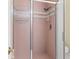 Shower featuring a glass door and pink tile for a retro, clean, and functional bathroom at 2782 Countryside Blvd # 2, Clearwater, FL 33761