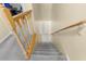 Carpeted staircase with wooden railing leads to the upper or lower levels of the home at 2782 Countryside Blvd # 2, Clearwater, FL 33761
