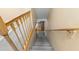 Carpeted stairs leading upstairs with wood railing at 2782 Countryside Blvd # 2, Clearwater, FL 33761