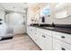 Bathroom showcasing dual sinks and a frameless glass shower at 28628 Bennington Dr, Wesley Chapel, FL 33544