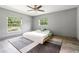 Bedroom featuring two large windows and neutral colored walls and wood look tile flooring at 28628 Bennington Dr, Wesley Chapel, FL 33544