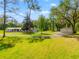 View of property with two garages and home on a bright green lawn at 28628 Bennington Dr, Wesley Chapel, FL 33544
