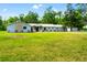 Well-maintained home set on a spacious lawn with lush landscaping, featuring a detached garage at 28628 Bennington Dr, Wesley Chapel, FL 33544