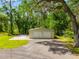 Detached two car garage adjacent to home with lush green surroundings at 28628 Bennington Dr, Wesley Chapel, FL 33544