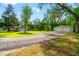 A detached two-car garage sits on a large lot with mature trees and plenty of green space at 28628 Bennington Dr, Wesley Chapel, FL 33544