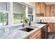 Close-up of kitchen sink and countertops with stainless steel appliances and a view of the outdoor area at 28628 Bennington Dr, Wesley Chapel, FL 33544