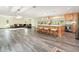 Open concept kitchen with wood cabinets, marble countertops, and an island with bar stool seating at 28628 Bennington Dr, Wesley Chapel, FL 33544
