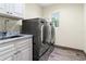 Modern laundry room with washer and dryer and gray marbled countertops at 28628 Bennington Dr, Wesley Chapel, FL 33544