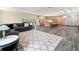 Bright living room with open kitchen, breakfast bar, and sliding glass doors at 28628 Bennington Dr, Wesley Chapel, FL 33544