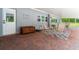 Covered patio with brick pavers, seating area, and backyard access at 28628 Bennington Dr, Wesley Chapel, FL 33544