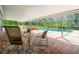 Screened pool area with a spa, seating, and brick-paved deck at 28628 Bennington Dr, Wesley Chapel, FL 33544